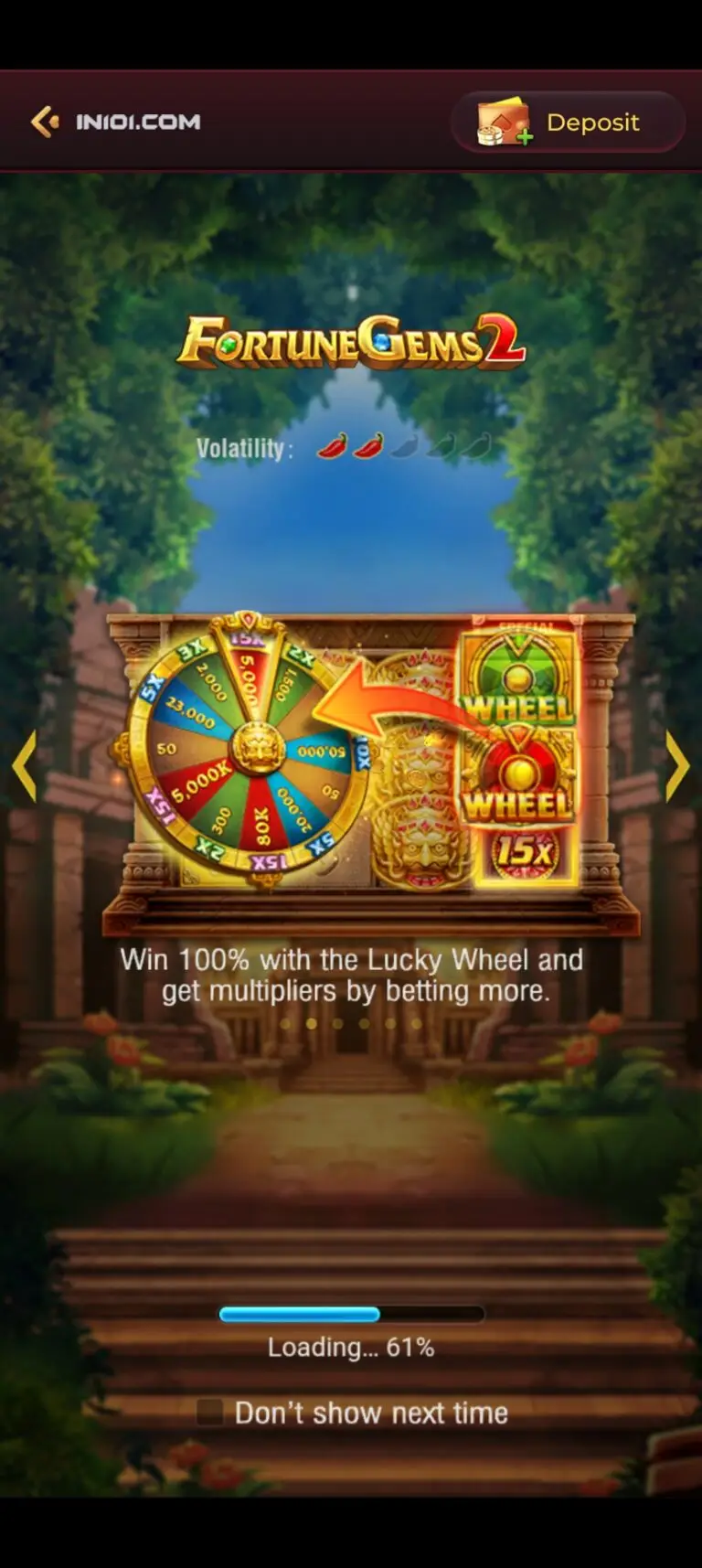 IN101 Game loading screen for the Fortune Gems 2 slot machine. The display features a golden lucky wheel with multiplier segments, a medium volatility rating of two chili peppers, and the text 'Win 100% with the Lucky Wheel and get multipliers by betting more.' A loading bar indicates 61% progress.